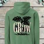 Large back print of a monstera plant silhouette behind the word GROW in serif capitals