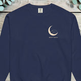 Small design of a fox curled asleep inside a crescent moon above the words REST EASY