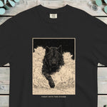 Black wolf pushing through deep snow inside a framed vintage plate