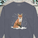 Red fox sitting on snow-covered ground with heavy snow falling around it