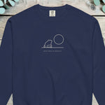 Small single-line design of a frog sitting beside a full moon on a horizon line