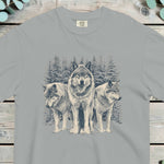 Three wolves standing in deep snow in front of snow-covered pine trees