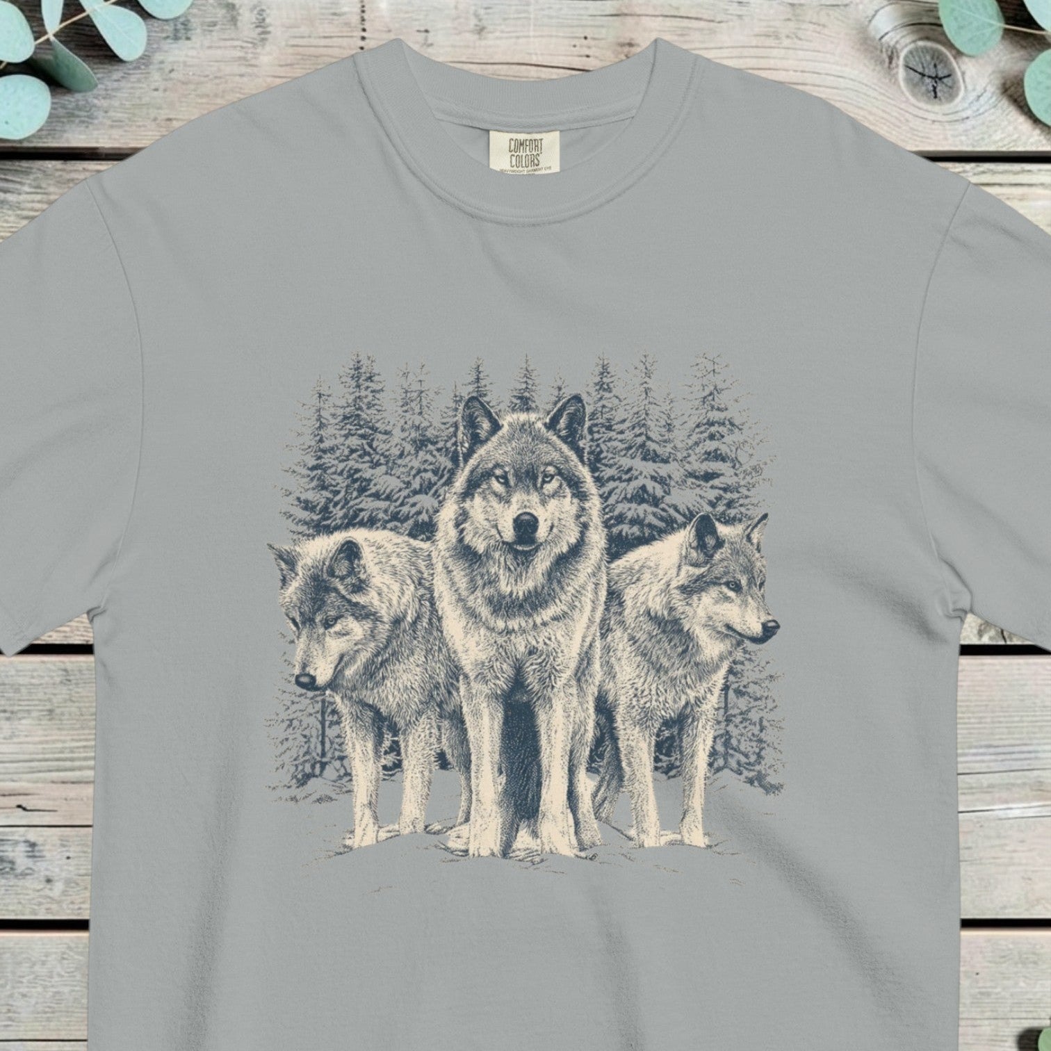 Three wolves standing in deep snow in front of snow-covered pine trees