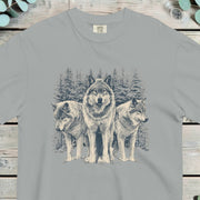 Three wolves standing in deep snow in front of snow-covered pine trees