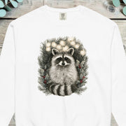 Raccoon peering out from inside a pine wreath strung with small lights