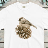 Small sparrow perched on an open pine cone, worked in soft sepia tones