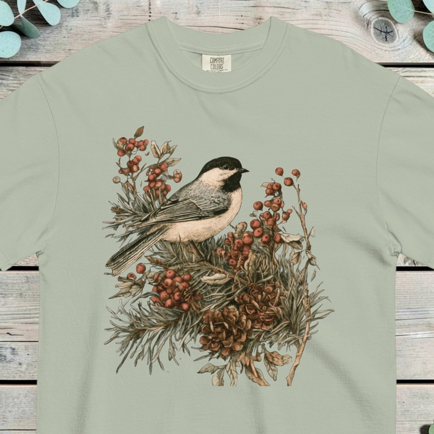 Black-capped chickadee perched on a pine sprig heavy with orange berries