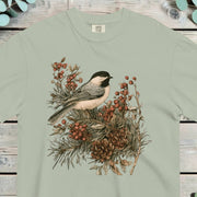 Black-capped chickadee perched on a pine sprig heavy with orange berries