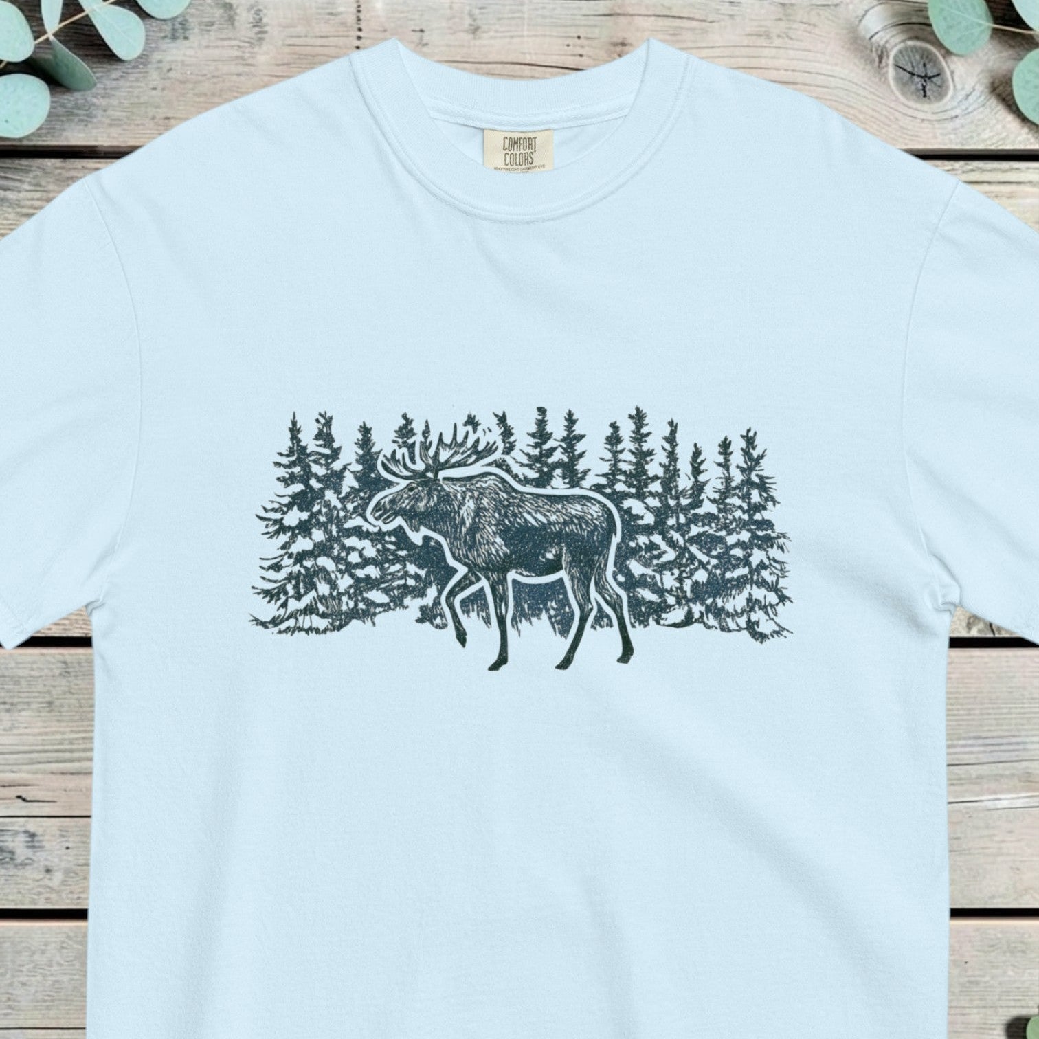 Moose walking through a snowy pine forest in cool blue line work