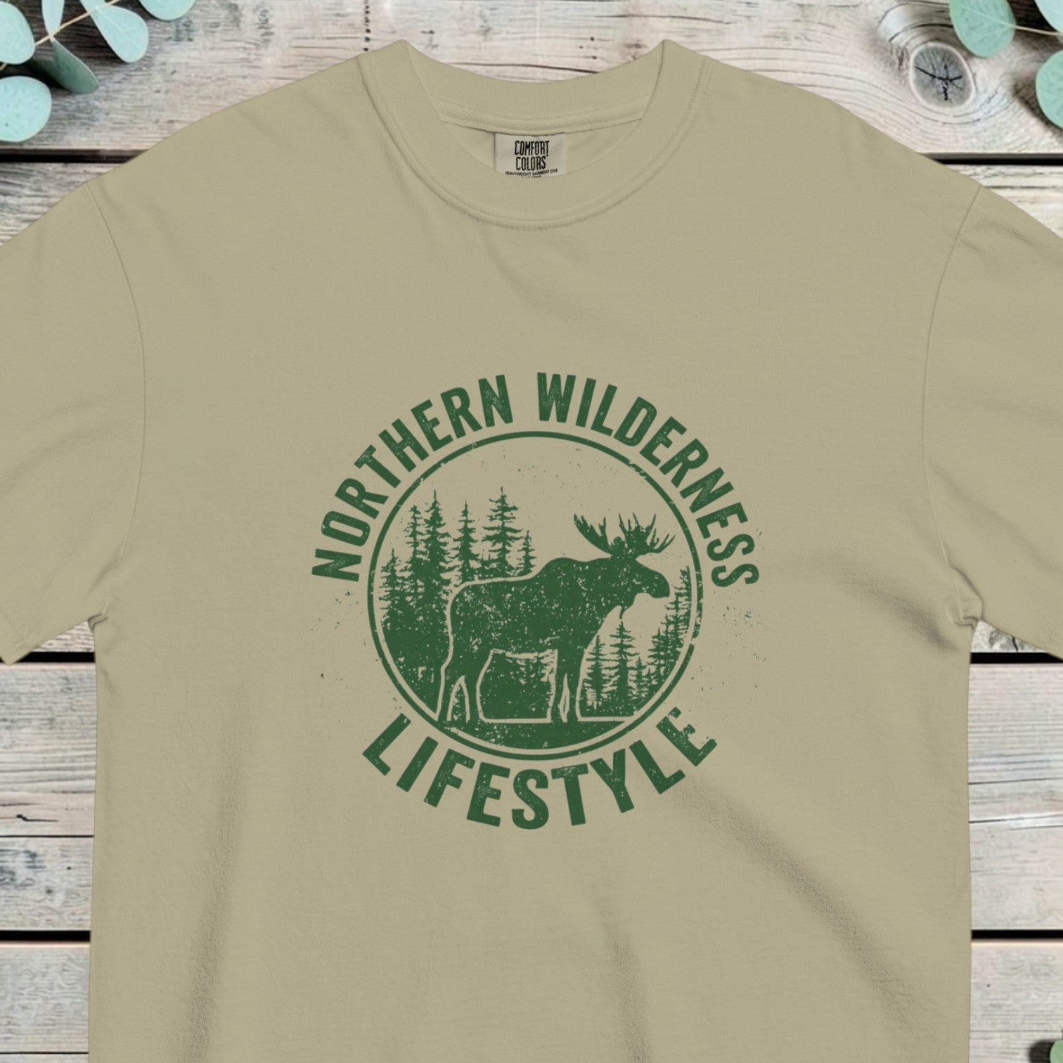 Circular badge with a moose in pine woods, reading NORTHERN WILDERNESS and LIFESTYLE