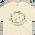 Frog sitting inside a holly wreath worked in fine green line