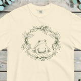 Frog sitting inside a holly wreath worked in fine green line