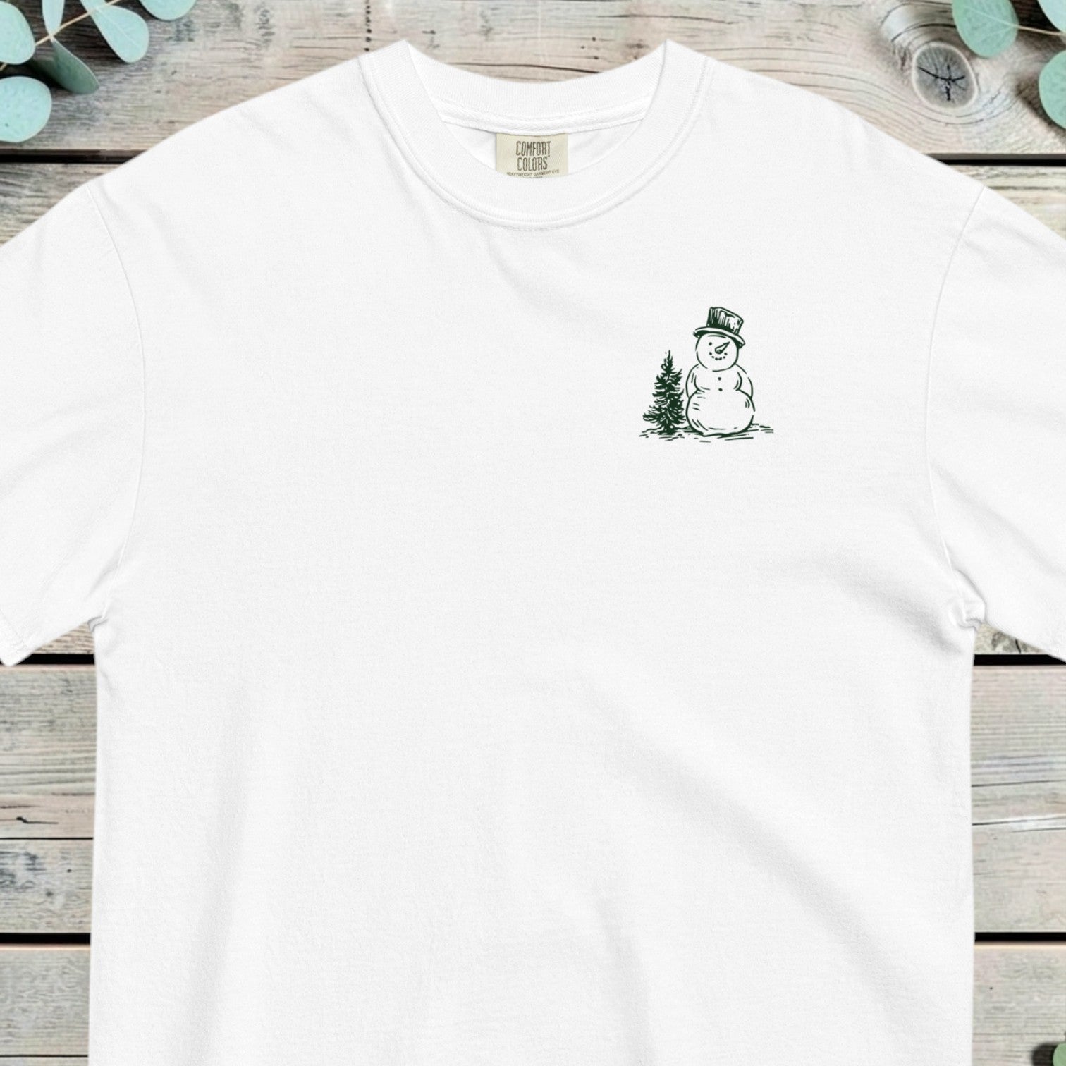 Small chest design of a top-hatted snowman standing beside a pine tree