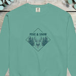 Stag head between pines in a diamond frame with PINE AND SNOW above, on a sweatshirt
