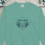 Stag head between pines in a diamond frame with PINE AND SNOW above, on a sweatshirt