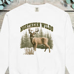 Whitetail buck standing in front of a pine forest with NORTHERN WILDS arched above