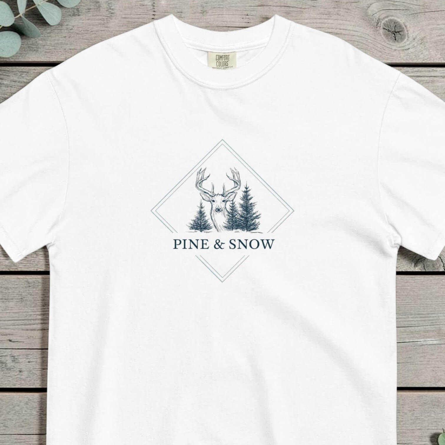 Deer and winter forest design on a White garment-dyed cotton t-shirt