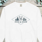 Stag head flanked by pine trees inside a diamond with PINE AND SNOW beneath it