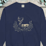 Pale stag standing among pine boughs on a deep navy sweatshirt