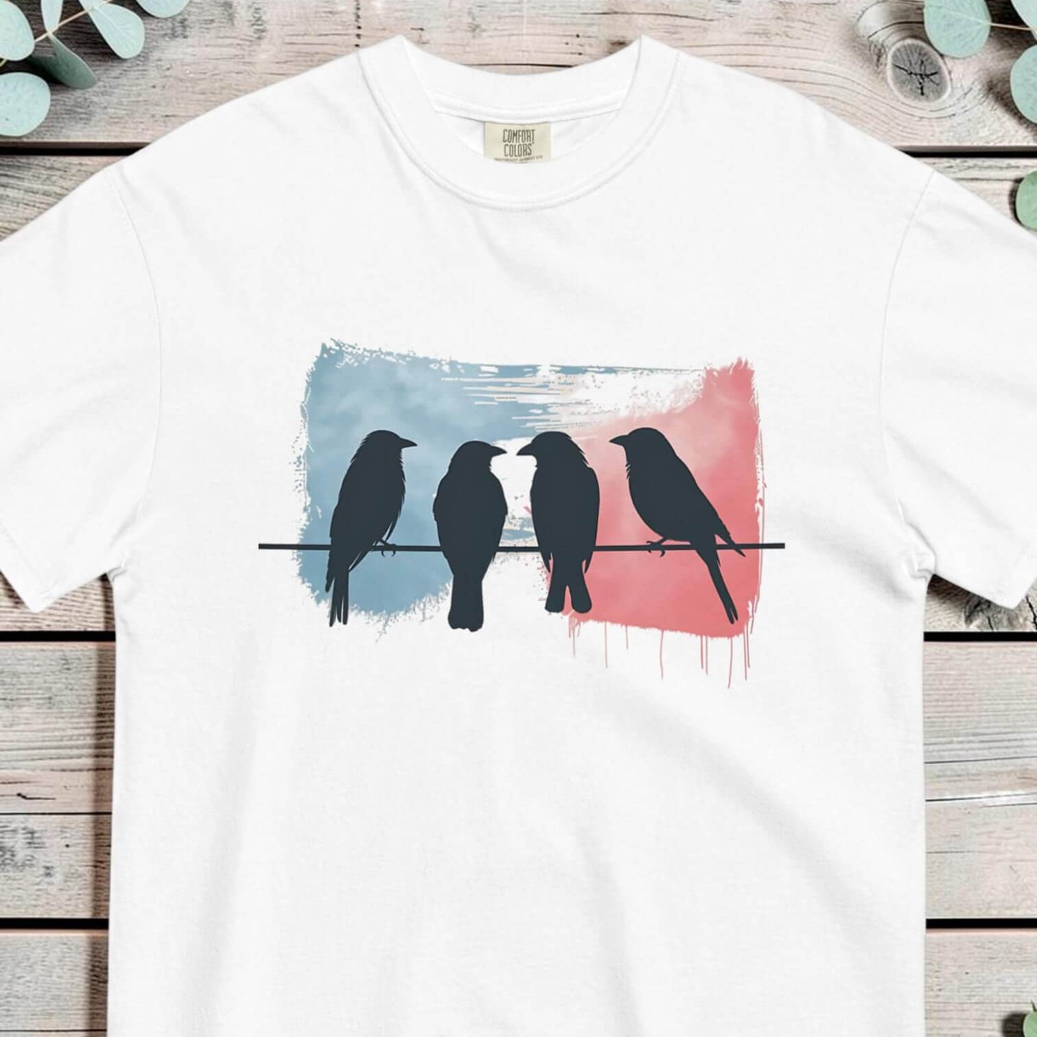 Birds on a wire design on a White garment-dyed cotton t-shirt