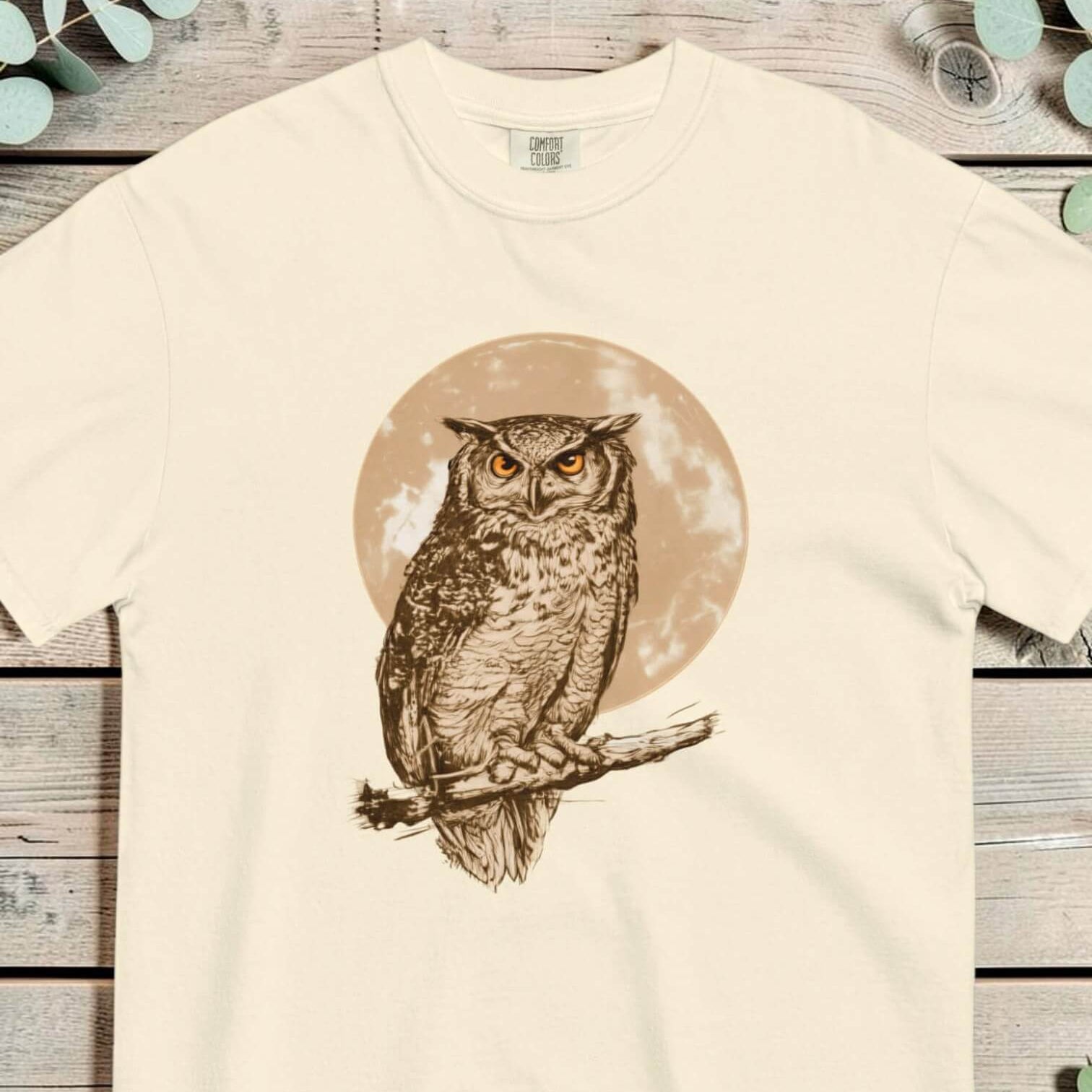 Great horned owl and moon design on an Ivory garment-dyed cotton t-shirt