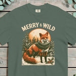 Red fox wearing a knitted scarf in snow, looking out, with pines and a full moon behind