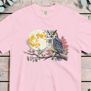 Great horned owl on a leafy branch against a golden moon surrounded by red autumn leaves
