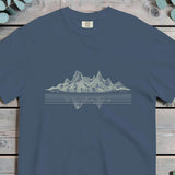 Jagged mountain range in vertical hatching mirrored in still water below a waterline