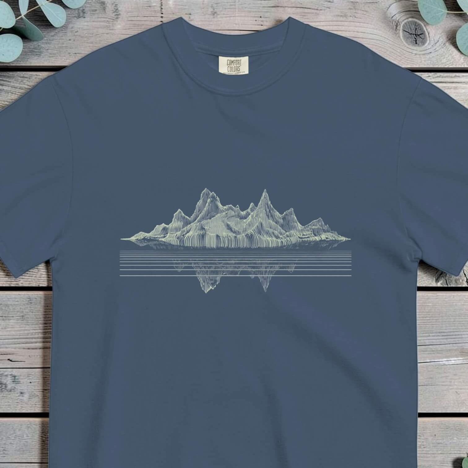 Jagged mountain range in vertical hatching mirrored in still water below a waterline