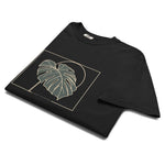 Monstera leaf design on a Black garment-dyed cotton t-shirt