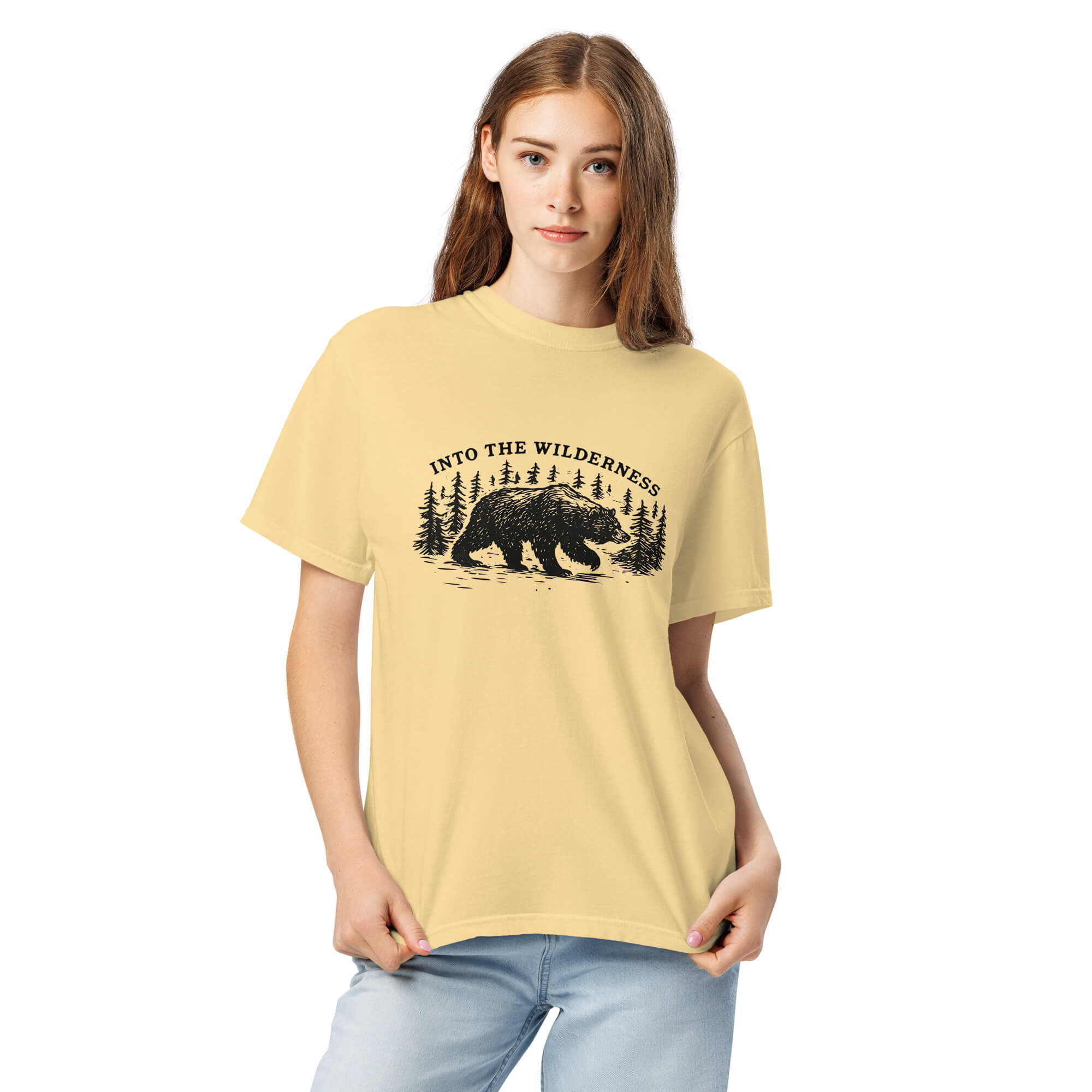 Bear and pine forest wilderness design on a Butter garment-dyed cotton t-shirt