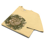 Fox asleep in a Christmas wreath design on a Butter garment-dyed cotton t-shirt