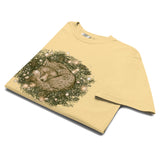 Fox asleep in a Christmas wreath design on a Butter garment-dyed cotton t-shirt