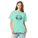 Stag emblem with pine and snow design on a Chalky Mint garment-dyed cotton t-shirt