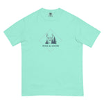 Deer and winter forest design on a Chalky Mint garment-dyed cotton t-shirt
