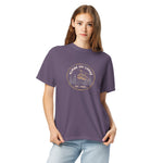 Alpine ski lodge gondola badge design on a Grape garment-dyed cotton t-shirt