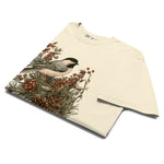 Chickadee and winter berries design on an Ivory garment-dyed cotton t-shirt