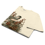Chickadee and winter berries design on an Ivory garment-dyed cotton t-shirt