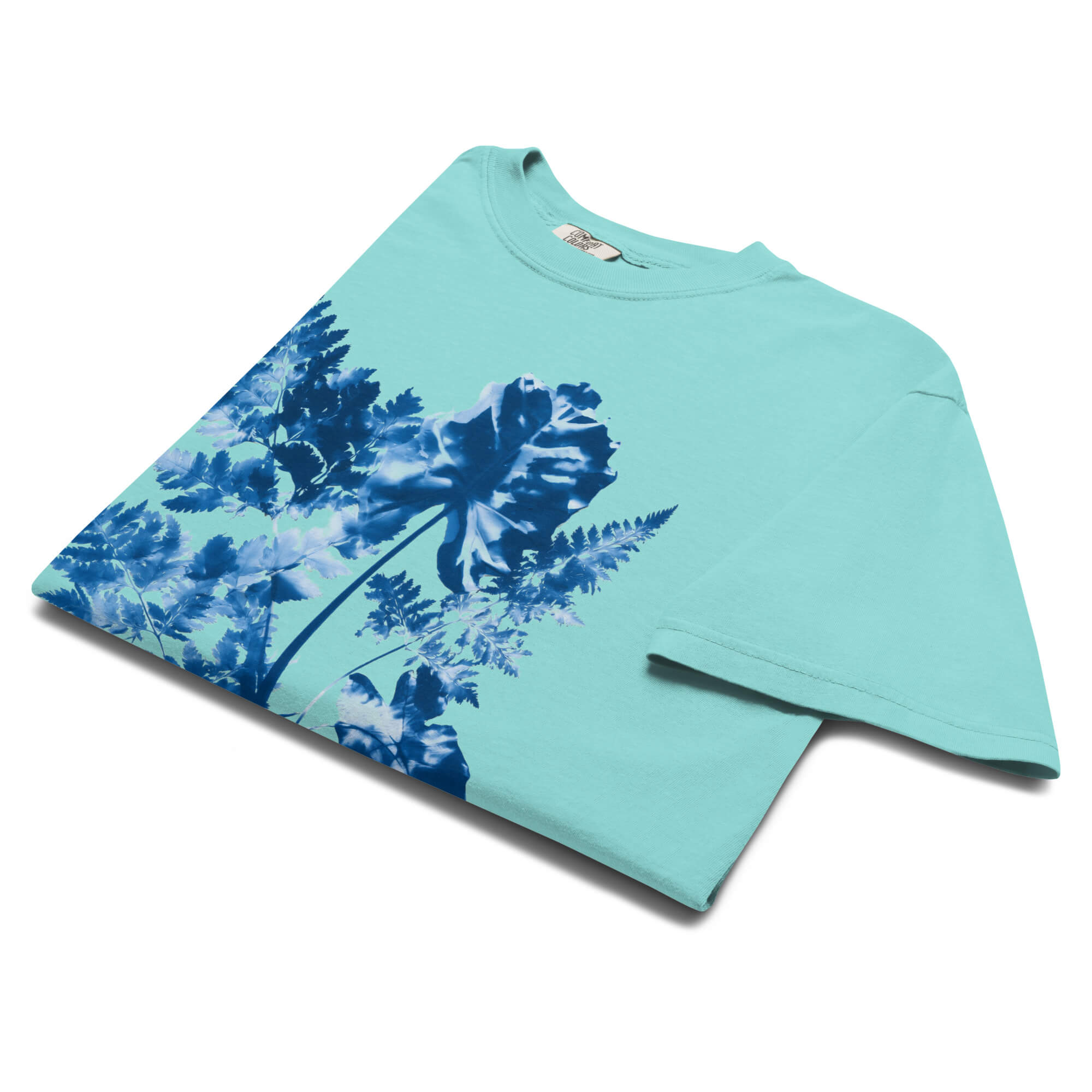 Fern and leaf cyanotype design on a Lagoon Blue garment-dyed cotton t-shirt