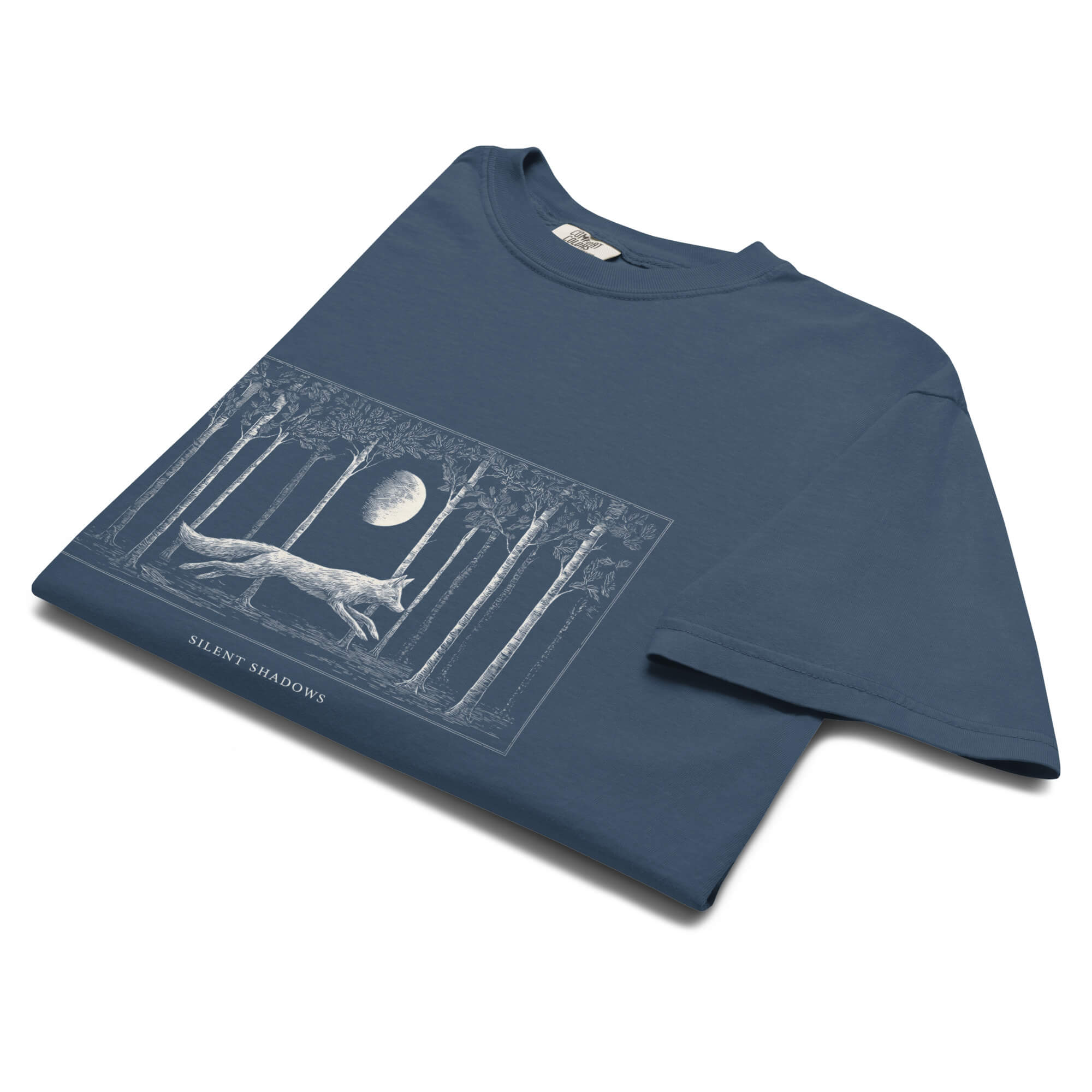 Running fox moonlit forest design on a Midnight garment-dyed cotton t-shirt