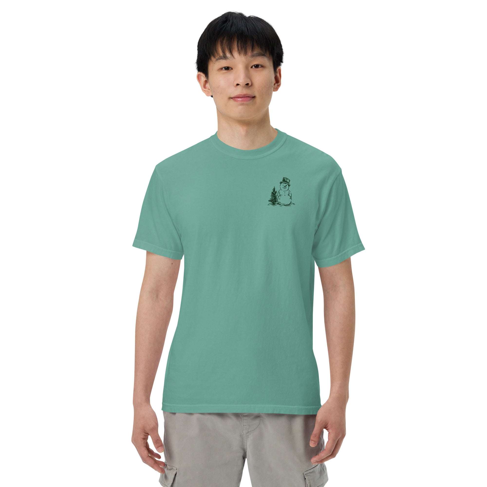 Snowman and pine tree design on a Seafoam garment-dyed cotton t-shirt