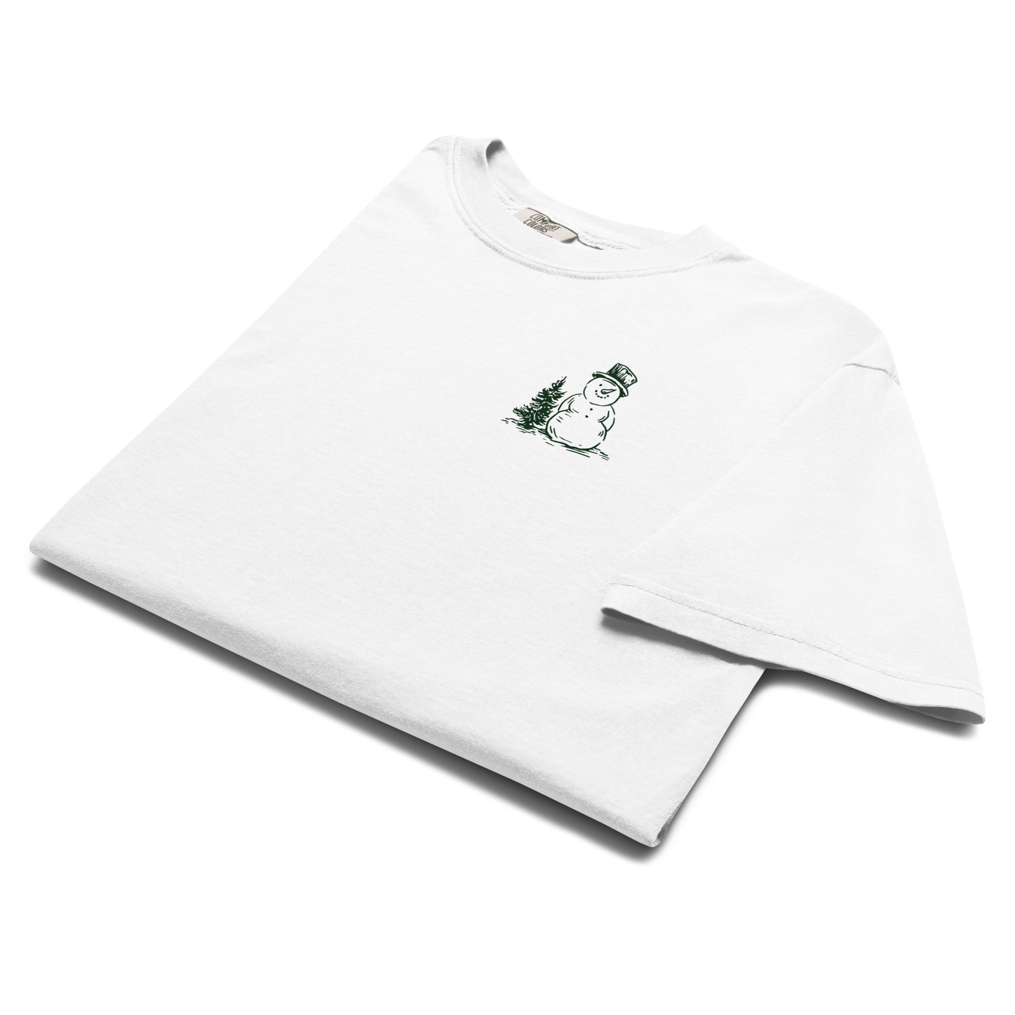 Snowman and pine tree design on a White garment-dyed cotton t-shirt