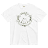 Frog in a holly wreath design on a White garment-dyed cotton t-shirt