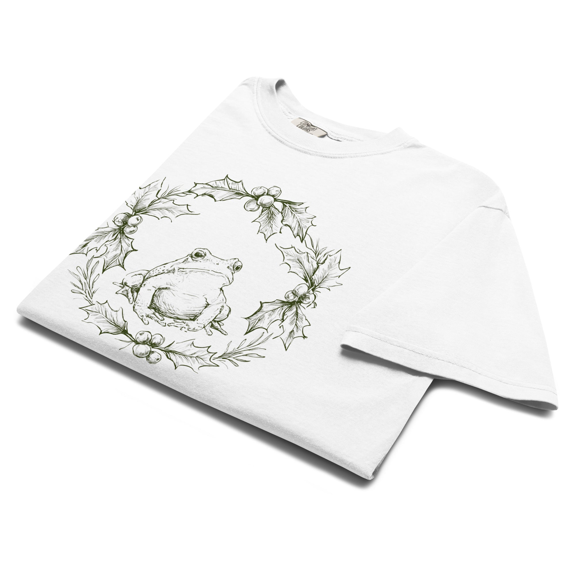 Frog in a holly wreath design on a White garment-dyed cotton t-shirt