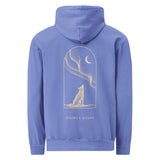 Howling white wolf under the aurora design on a Flo Blue garment-dyed hooded sweatshirt