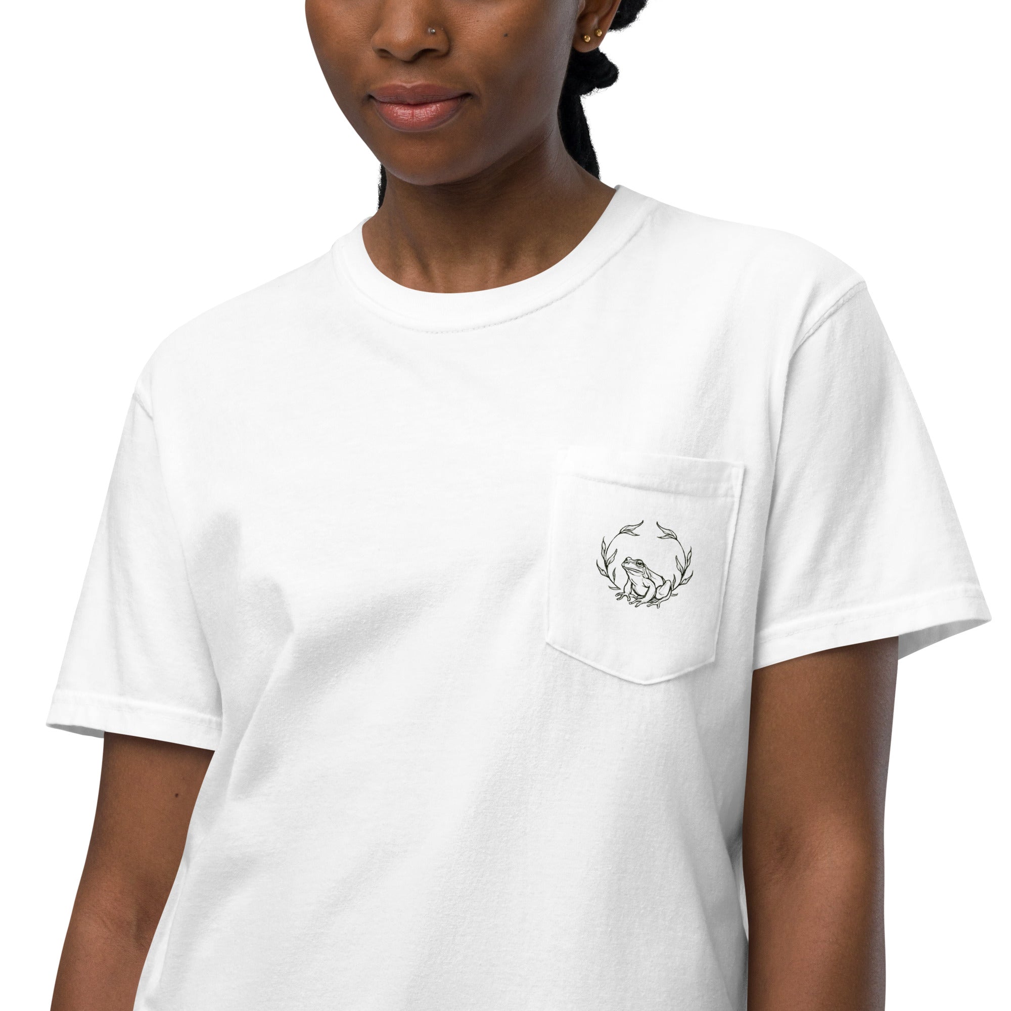 Frog and holly wreath pocket design on a White garment-dyed cotton pocket t-shirt