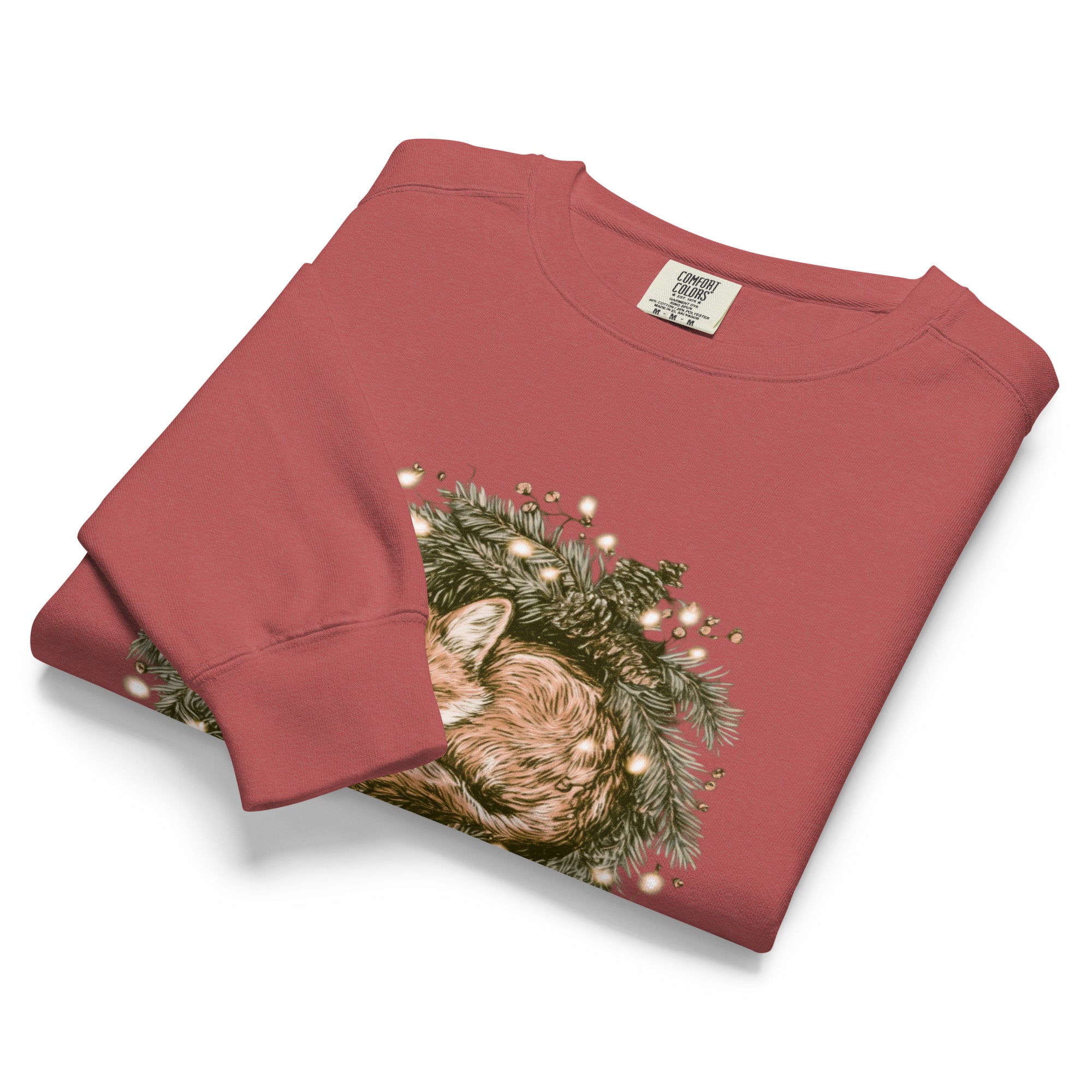 Fox asleep in a Christmas wreath design on a Crimson garment-dyed sweatshirt