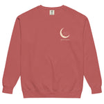 Sleepy fox in a crescent moon design on a Crimson garment-dyed sweatshirt