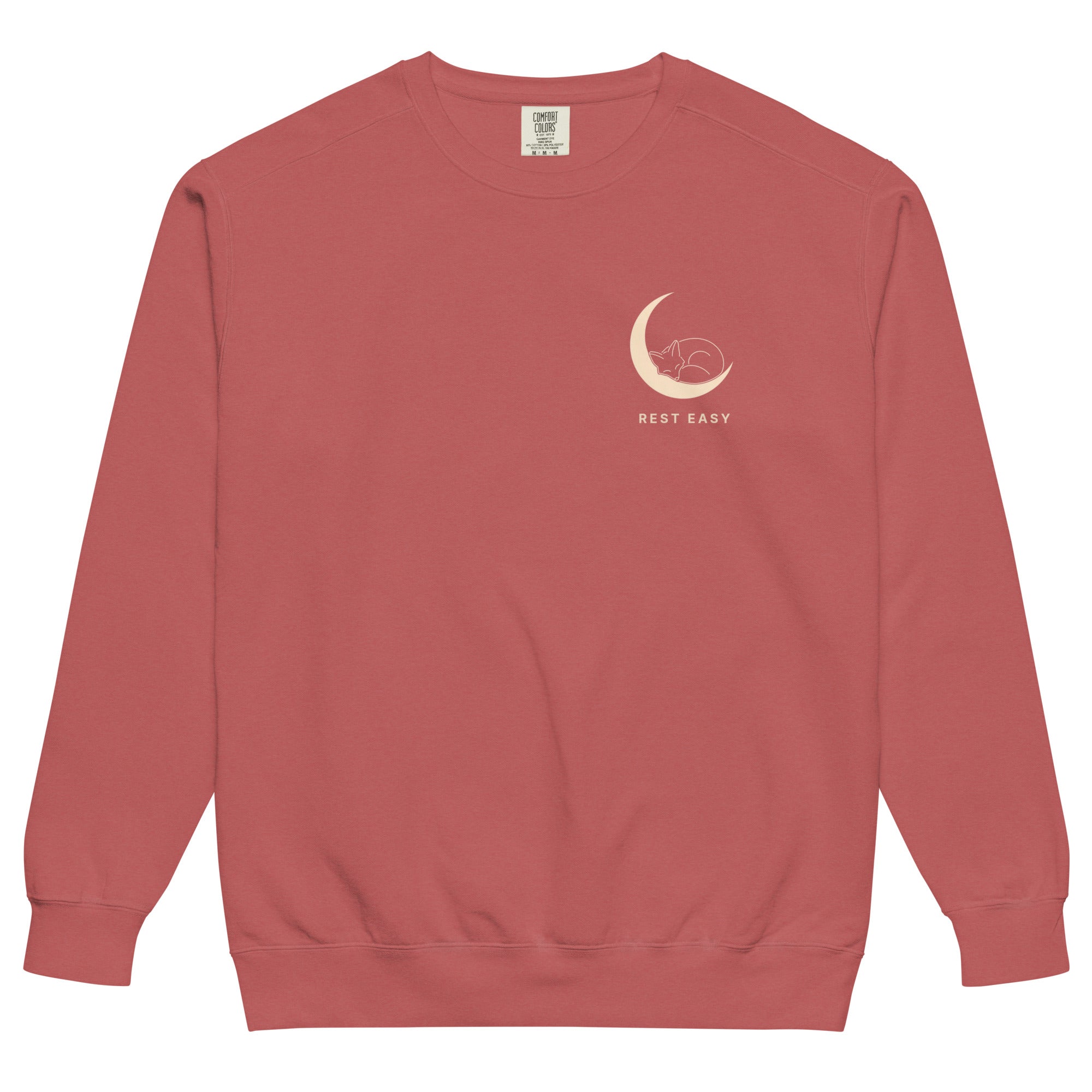 Sleepy fox in a crescent moon design on a Crimson garment-dyed sweatshirt
