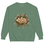 Fox asleep in a Christmas wreath design on a Light Green garment-dyed sweatshirt